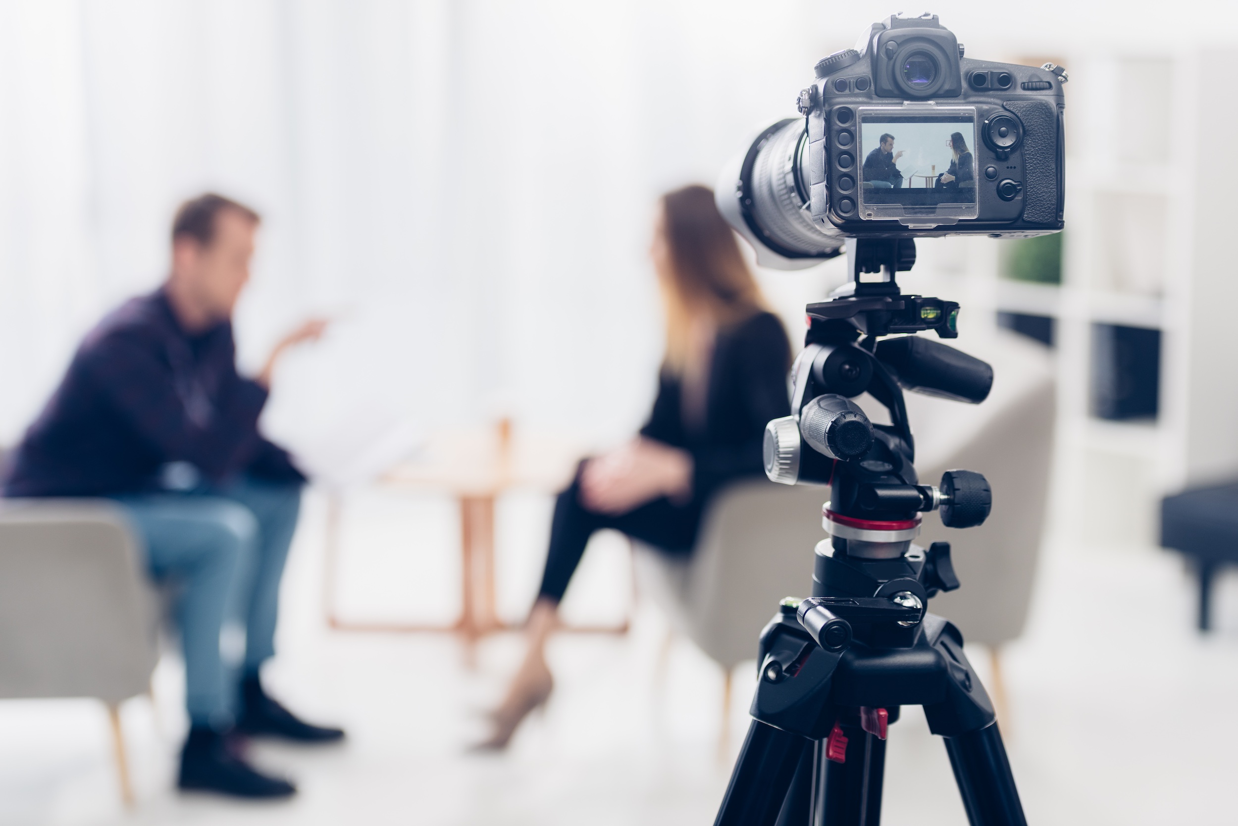 Two people talking with camera recording